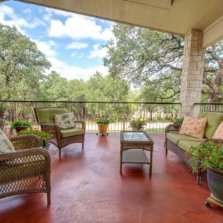A cozy patio with outdoor seating offering a relaxing nature view.