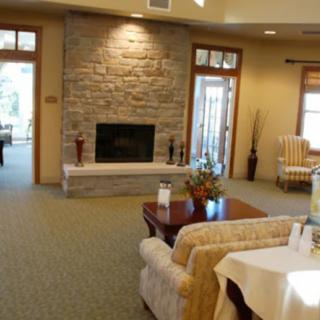 A cozy living room featuring a stone fireplace and comfortable seating.