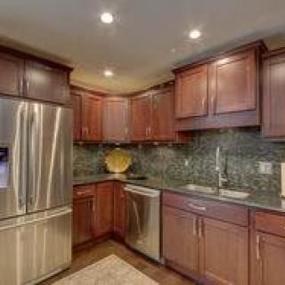 Modern kitchen with wooden cabinets and stainless steel appliances.