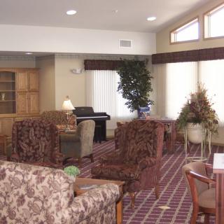 A cozy living room with patterned furniture and warm lighting.