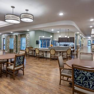 A spacious dining area with modern lighting and hardwood flooring.