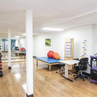 A spacious physical therapy clinic featuring therapy balls and exercise equipment, ready for patient treatment.