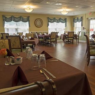 A cozy dining area set with tables and chairs, ready for guests.