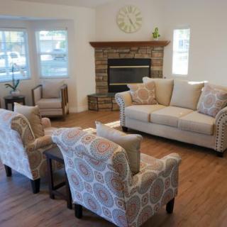 A cozy living room with a sofa set and fireplace.