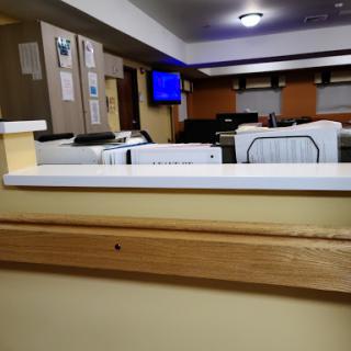 A view of an office space featuring furniture and a TV in the background.