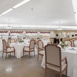 A spacious and elegantly decorated dining room with neatly arranged tables and chairs.
