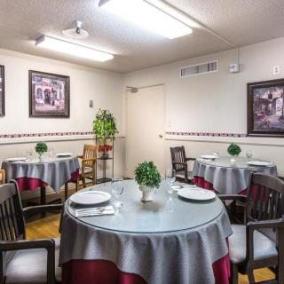 A cozy dining area with elegantly set tables and tasteful decor.