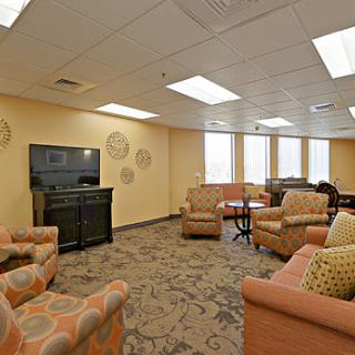 A cozy lounge space featuring comfortable seating and a television, perfect for relaxation.