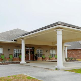 A well-designed entrance of a residential building featuring columns.
