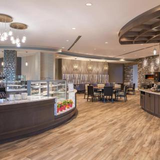 A modern cafe interior with stylish seating and contemporary lighting.