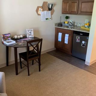 A small, cozy kitchen in an apartment with a table and chair setup.