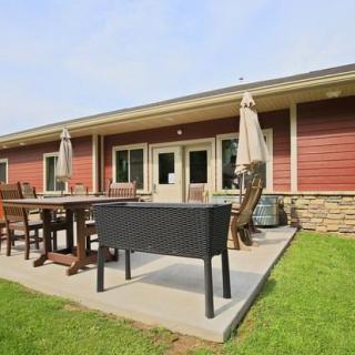A patio with outdoor furniture and umbrellas outside a building.