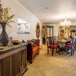 A cozy dining room with elegant decor and a chandelier.
