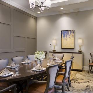 An elegant dining room with a large table, comfortable chairs, and tasteful decor.
