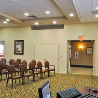 A well-lit waiting area featuring rows of upholstered chairs and a welcoming atmosphere.