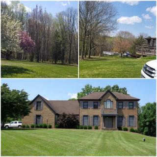 A suburban house with a well-maintained lawn and surrounding trees.