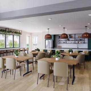 A modern dining area featuring sleek furniture, warm lighting, and plenty of greenery.