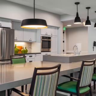 A modern kitchen showcasing sleek design with an island and contemporary lighting.