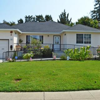 A single-story house with a well-maintained front yard and garden.