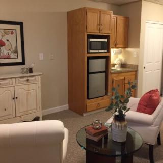 A cozy living room featuring elegant furniture and a built-in oven with cabinets.