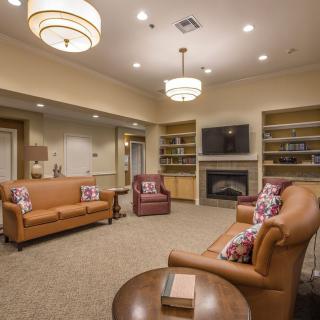A cozy living room with comfortable seating and warm lighting.
