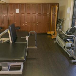 A gym locker room with fitness equipment and exercise machines.