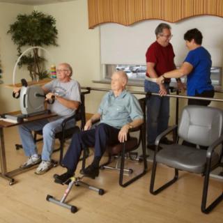 Elderly individuals engaging in physical therapy exercises at a healthcare facility.