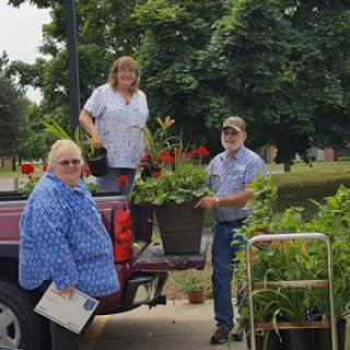 Volunteers work together to plant flowers and beautify the community.