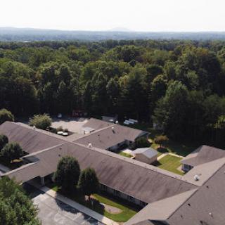 A serene aerial view of a residential area surrounded by lush greenery.