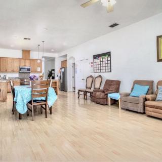 Bright open living and dining area with a view of the kitchen.