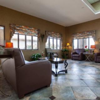A spacious living room with large windows, comfortable seating, and elegant decor.