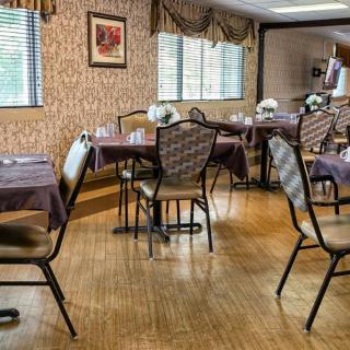 An empty dining room with decorated tables and chairs.