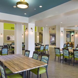 A modern dining area with vibrant decor and well-arranged tables and chairs.