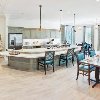 A spacious, modern kitchen and dining area with an island counter and elegant pendant lighting.