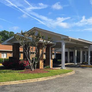 A welcoming entrance to a well-maintained building on a sunny day.
