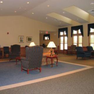 A spacious lobby with comfortable seating and soft lighting.