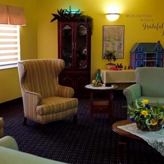 A cozy living room with armchairs, a sofa, and decorative elements.