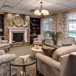 A cozy and elegant living room with comfortable seating, a fireplace, and tasteful decor.
