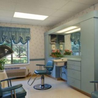 A well-lit hair salon interior with chairs and mirrors.