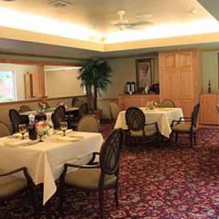 A cozy dining room with elegantly set tables and a warm atmosphere.