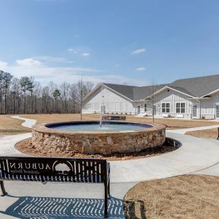 An outdoor area featuring a circular fountain surrounded by benches and pathways.