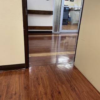 A view through a doorway showcasing polished wooden flooring in an indoor space.