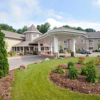 Exterior view of a hotel with landscaped gardens and a prominent entrance.