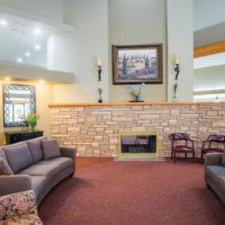 A spacious living room with modern decor, featuring comfortable sofas and a fireplace.
