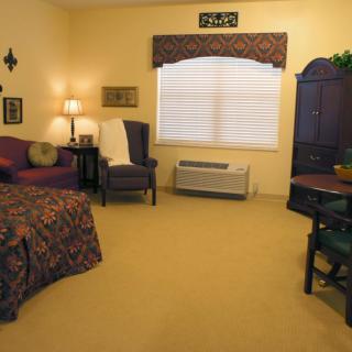 A cozy living space with warm lighting, comfortable seating, and elegant decor.
