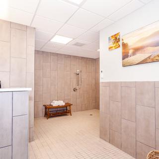 A spacious, modern bathroom featuring a walk-in shower and minimalistic dcor.