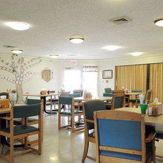 A bright and airy dining area with neatly arranged tables and chairs.