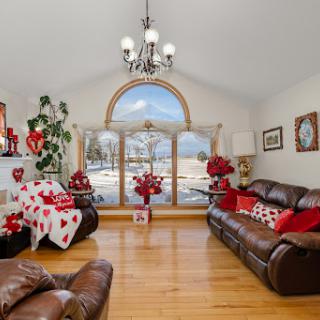 A beautifully decorated living room featuring a festive red and white theme, perfect for holiday gatherings.