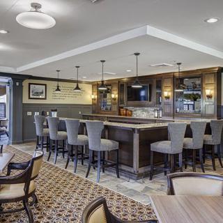 A modern bar area with comfortable seating and elegant lighting.