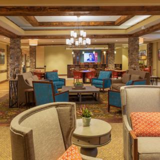 A cozy hotel lobby with modern furniture and a welcoming seating area.